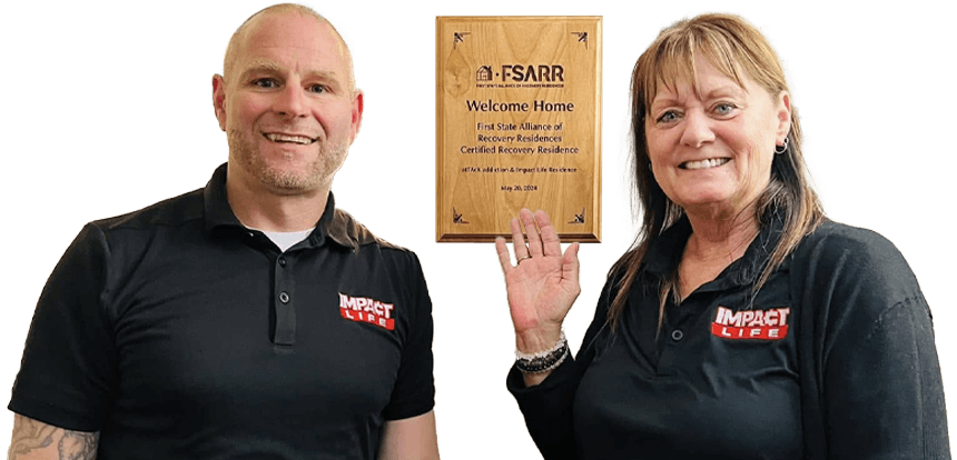 People standing with FSARR plaque